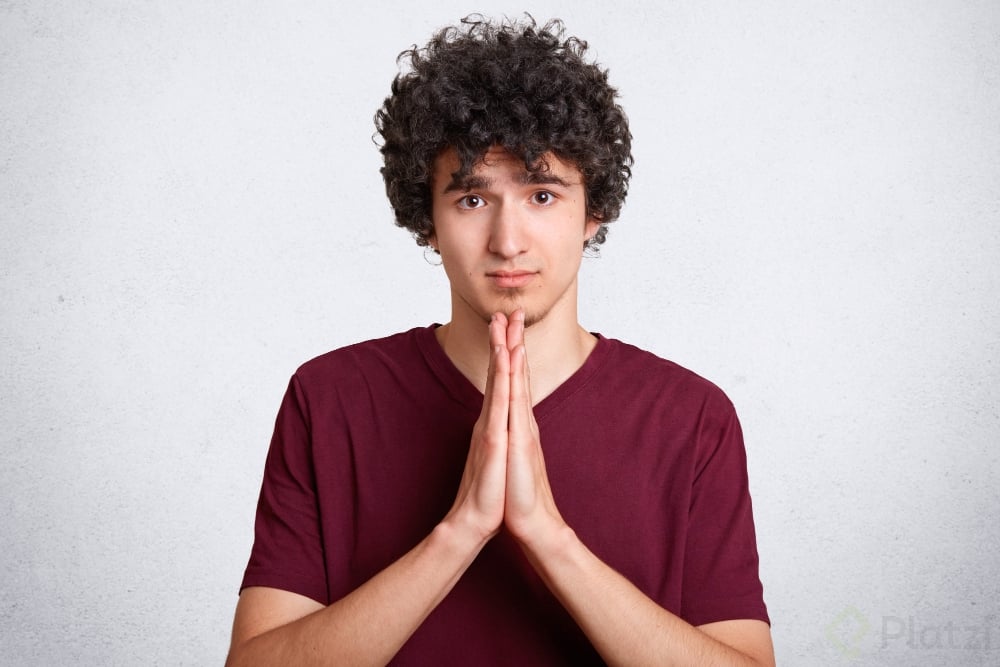 please-forgive-me-handsome-young-curly-male-makes-praying-gesture (1).jpg