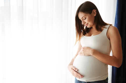 portrait-happy-pregnant-woman-touching-her-belly.png